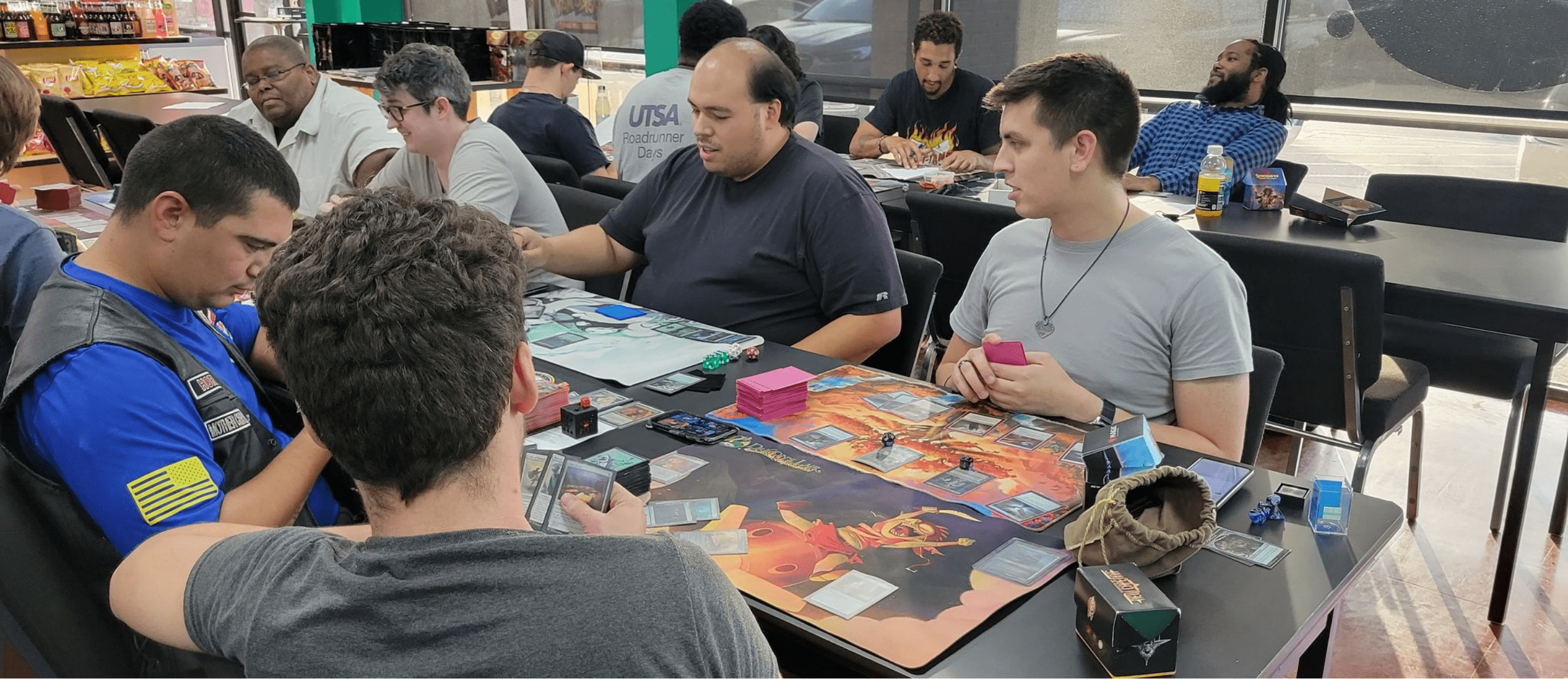 members of Dragon's Lair's inclusive gaming community at a Magic event